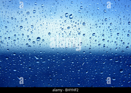 Abstract backdrop blue water drops on a boat glass window background Stock Photo