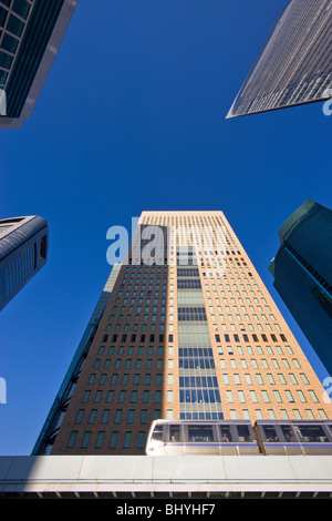 The automated New Transit Yurikamome Line train passes the new skyscrapers of the Shiodome business complex in the Shimbashi district of Tokyo, Japan. Stock Photo