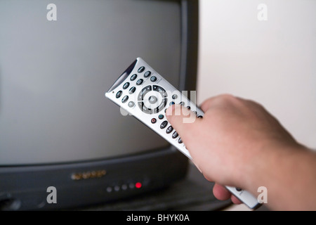 Hand holding a remote control Stock Photo