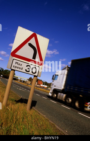 lorry passing warning sign of 30 mph speed limit and sharp left hand ...