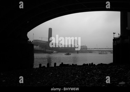 View of River Thames at Tate Modern and MIllennium Bridge from under Southwark Bridge, Bankside, London Stock Photo