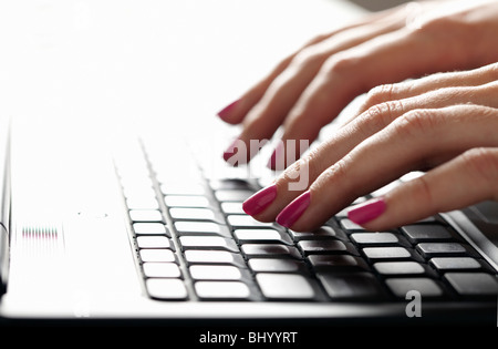 Female hands on computer keyboard Stock Photo