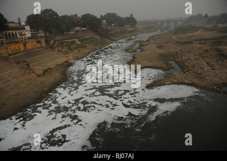 white frothy waste floating down river Stock Photo