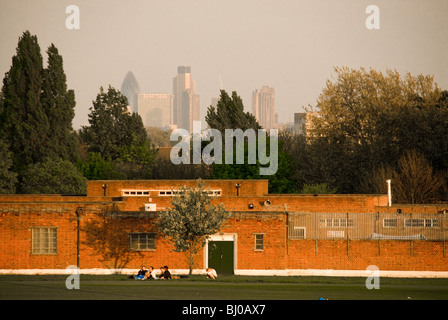 People relaxing on Parliament Fields with London in the background Stock Photo