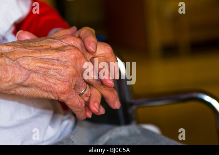 Womans aging hands folded Stock Photo