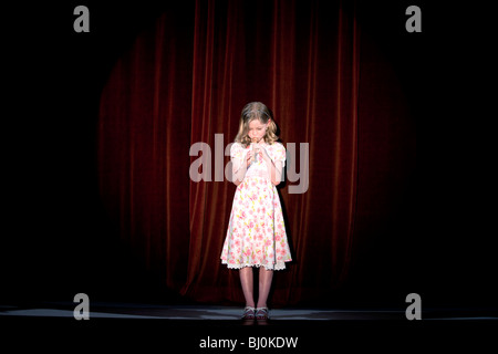 young girl playing recorder on stage Stock Photo