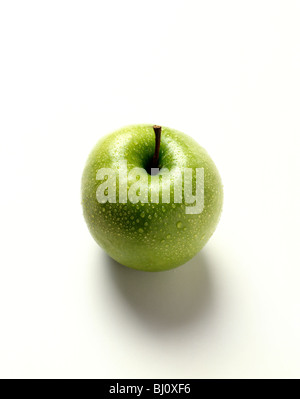 Still life of fresh green apple with water droplets on white background Stock Photo