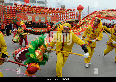 People perform a dragon dance during the 50th annual Spring Festival ...