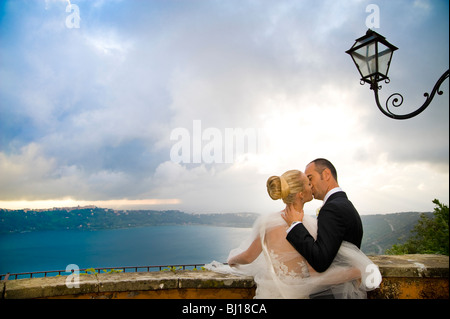 Bride and groom kissing on balcony in Italy Stock Photo