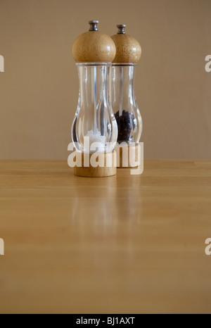 Salt and pepper mills on a table Stock Photo