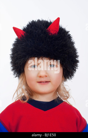 portrait of a cute boy with cap with horns isolated on white Stock Photo