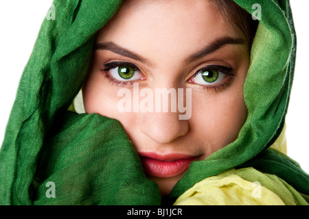 Portrait of mysterious beautiful Caucasian Hispanic Latina woman face with green penetrating eyes and green fashion scarf wrap. Stock Photo
