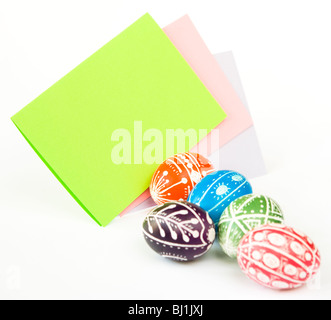 Colorful Easter eggs with blank paper copy space isolated on white background Stock Photo