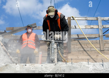 Construction worker using a jackhammer, Hamburg, Germany Stock Photo