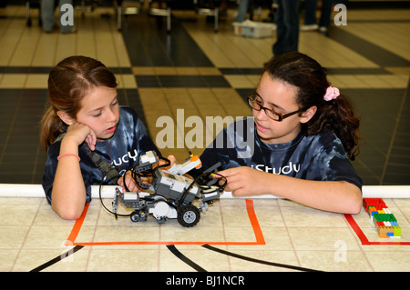 Two school girls working on a robot car. Stock Photo