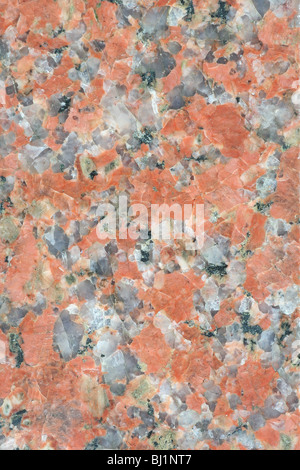 Polished granite surface with red, gray, black and white elements. Stock Photo