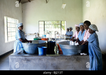 black female factory workers washing linen in Zimbabwe Stock Photo