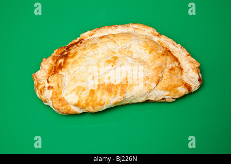 Cornish pastry on a green studio background. Stock Photo