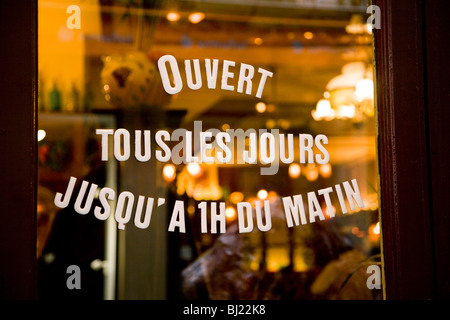 Opening hours displayed on the door of a Bouchon / restaurant / cafe / bistro bar in the city of Lyon, France. Stock Photo