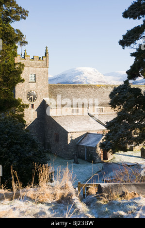 St Michael and All Angels Church at Hawkshead with Snow Covered Cumbrian Mountains Cumbria England United Kingdom UK Stock Photo