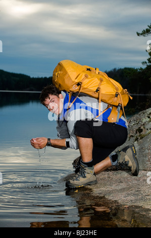 Portrait of a man hiking by a lake, Sweden. Stock Photo