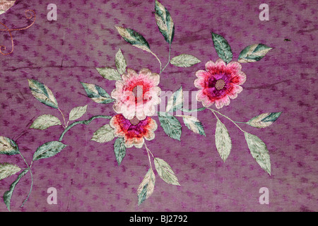 Antique Chinese silk fabric with hand embroidered floral design Stock Photo