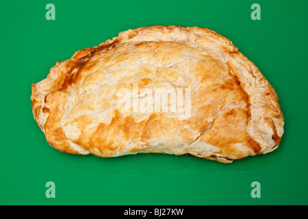 Cornish pastry on a green studio background. Stock Photo