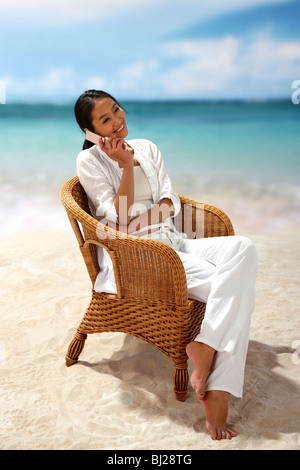 Young woman on beach,sitting Stock Photo