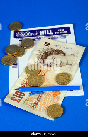 William Hill Betting slip with ten pound note and pound coins Stock Photo