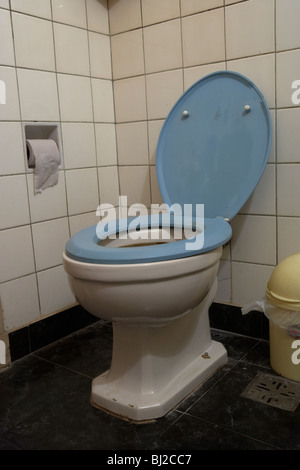 toilet with open lid in a run down bathroom in argentina south america Stock Photo