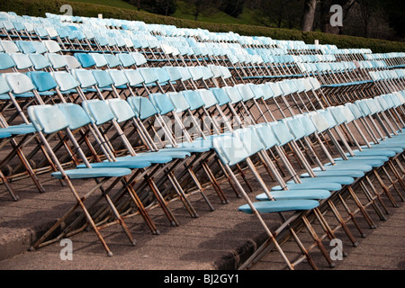 Rows of blue chairs set up in the auditorium of the Ross Bandstand in Edinburgh's Princes Street Gardens Stock Photo