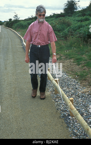 blind man using specially constructed access path on The Stiperstones National Nature reserve Shorpshire England Stock Photo