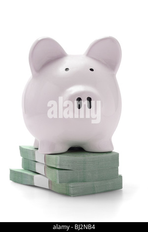 Piggy bank on stacks of money on white background Stock Photo