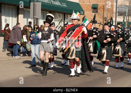 Band of Brothers Firefighter's pipe and drum corp with Guinness girl. 2010 St. Patrick's Day Parade. Forest Park, Illinois. Stock Photo