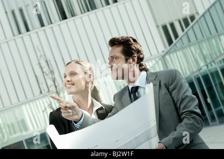 Businesspeople going over blueprints Stock Photo