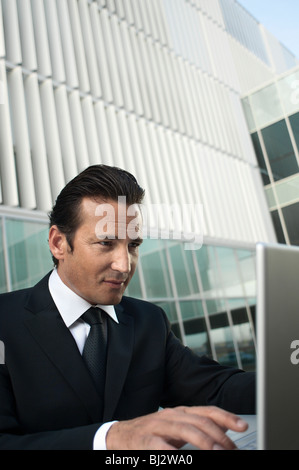 Businessman working on laptop outside Stock Photo