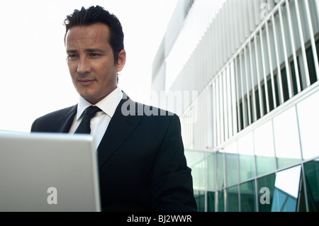 Businessman working on laptop outside Stock Photo