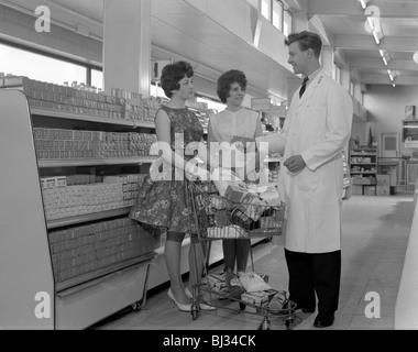 Supermarket shoppers and salesman, Co-op, Barnsley, South Yorkshire, 1961. Artist: Michael Walters Stock Photo