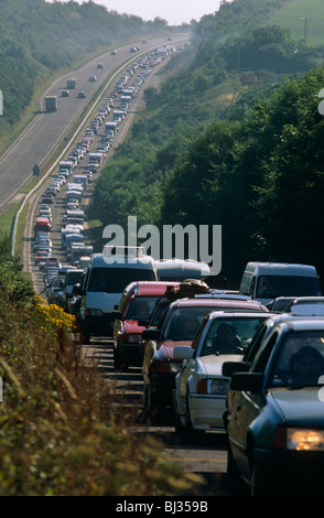 A chaotic holiday traffic jam on the A30 dual-carriageway at the start of the great getaway for family holidays. Stock Photo