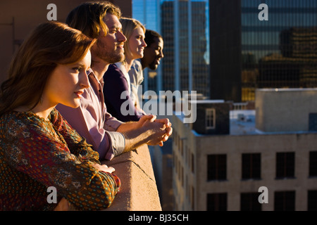 friends on roof top in city Stock Photo