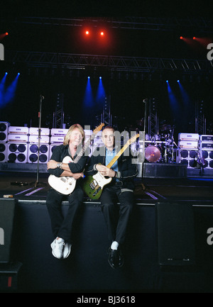Rick Parfitt (left) and Francis Rossi (right) Rossi are the two original members of the rock bank Status Quo, sitting on stage. Stock Photo