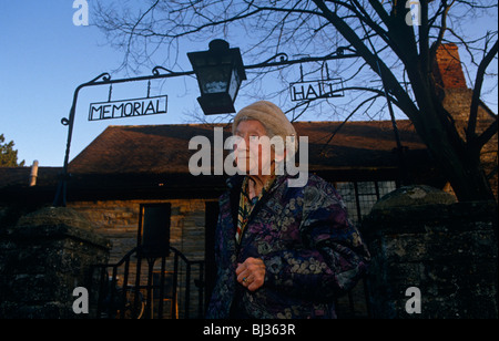 An elderly lady makes her way from her community village Memorial Hall which she has been volunteering this winter. Stock Photo