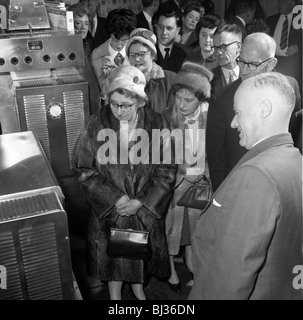 Women in fur coats at a food exhibition, Wilsic, near Doncaster, South Yorkshire, 1961.  Artist: Michael Walters Stock Photo