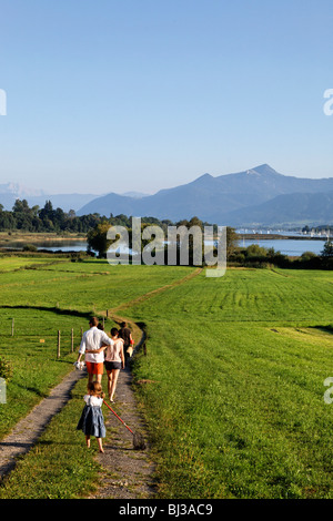 Young Family Walking on Pathway Schafwaschen, Chiemsee Chiemgau Upper Bavaria Germany