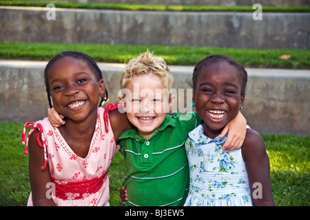 multi ethnic racial diversity diverse multicultural 4 year years old Caucasian boy happy smiling adoption sisters having fun looking at camera MR  © Myrleen Pearson Stock Photo