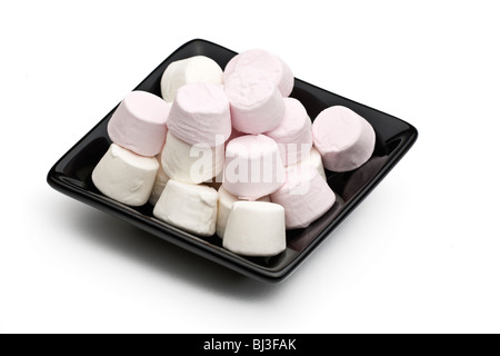 Black square ceramic plate filled with pink and white marshmallows on a white background Stock Photo