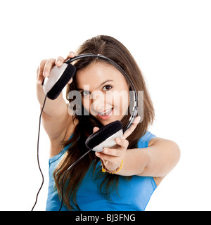Beautiful and happy young girl holding headphones, isolated on white Stock Photo