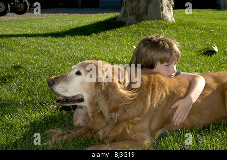Boy rests on dog