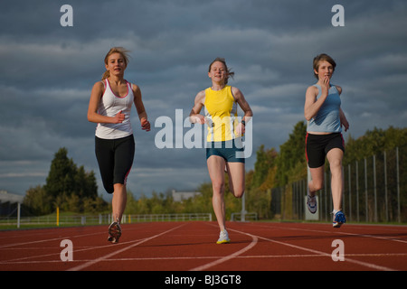 3 female athletes racing towards camera Stock Photo
