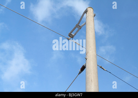 Overhead line at a railway track in front of blue sky, Germany Stock Photo